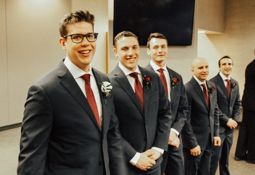 Steal of a Wedding groom and groomsmen in navy suits and marsala ties from Moore's