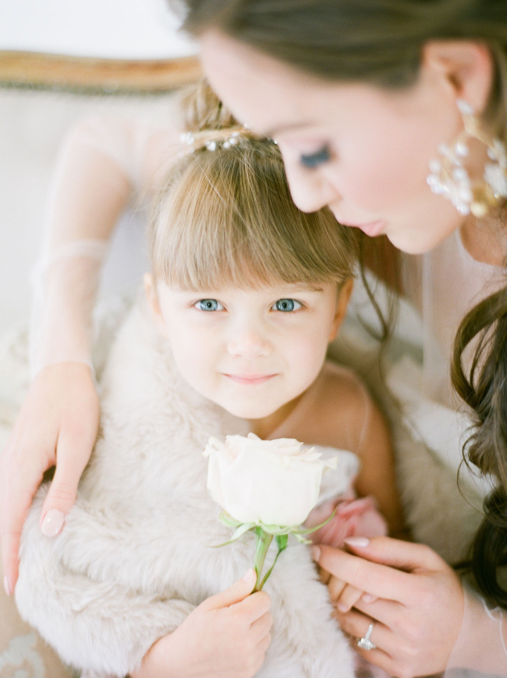 Flower girl holds white rose by Simply Sweet Photography