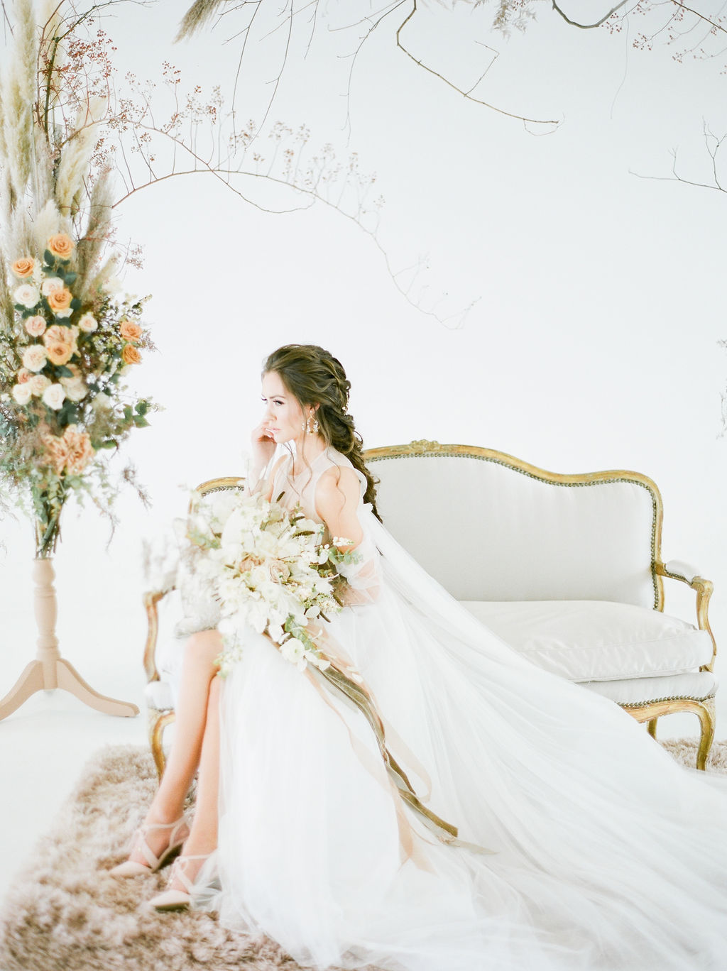 Vera Wang Bride on white settee in white space