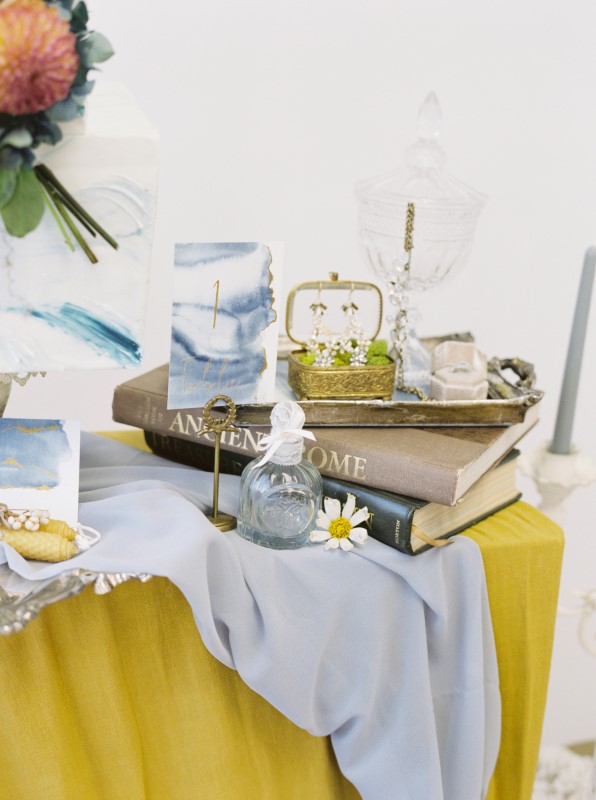 Silver Tray on Marigold Yellow Linen with Stack of Books and Decor