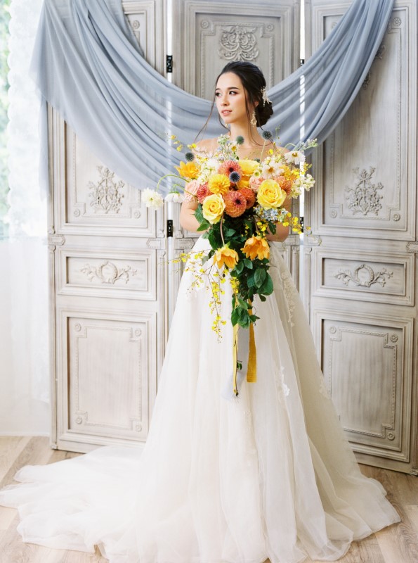 Exquisite Dusty Blue Wedding Inspiration Bride with large yellow and orange cascading bouquet by Ideal Events Vancouver