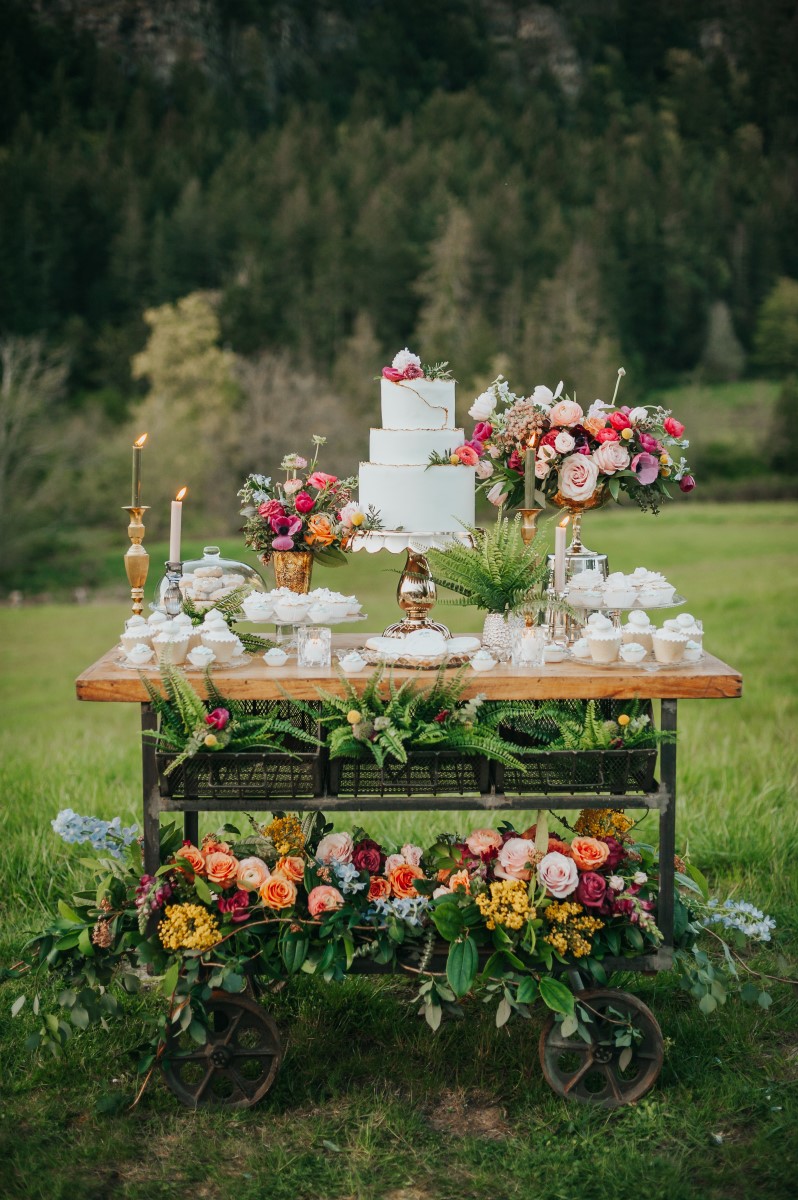 White Wedding Cake on Trolley of Flowers by Marvellous Cakes