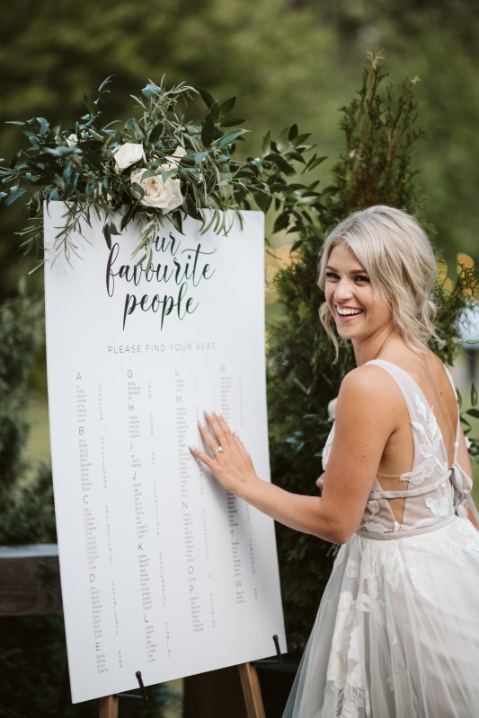 Bride reading Guest List made of parchment by Party Mood on Vancouver Island