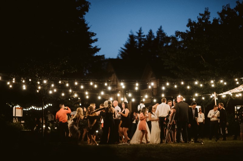 Wedding in the Woods guests dance under the stars and lights on Vancouver Island