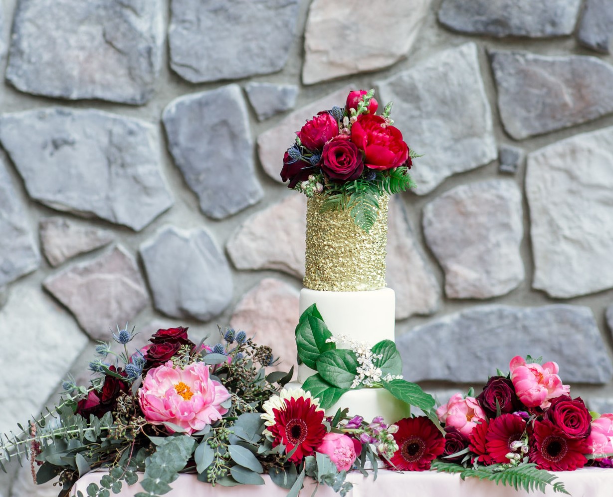 Wedding Cake surrounded by pink and red roses Thrifty Foods