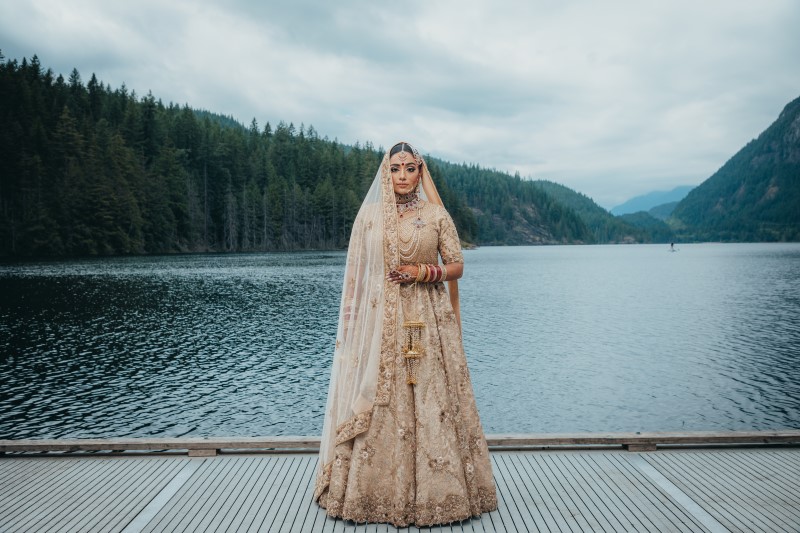 Bride wears Blush Saree in front of Rocky Mountain Lake near Vancouver