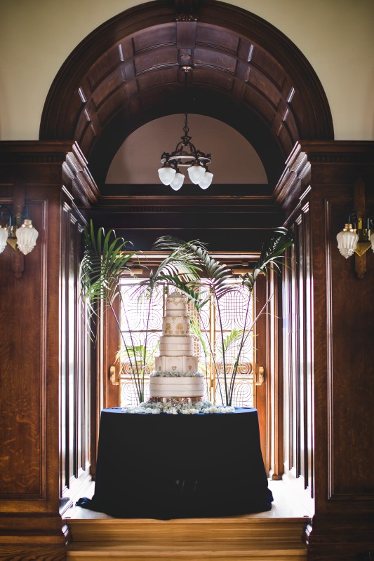 White Multi Layered Wedding Cake by Fairmont Empress chefs sits in window