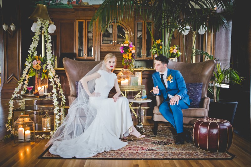 Bride and Groom Pose Sitting In the Bengal Lounge at The Fairmont Empress