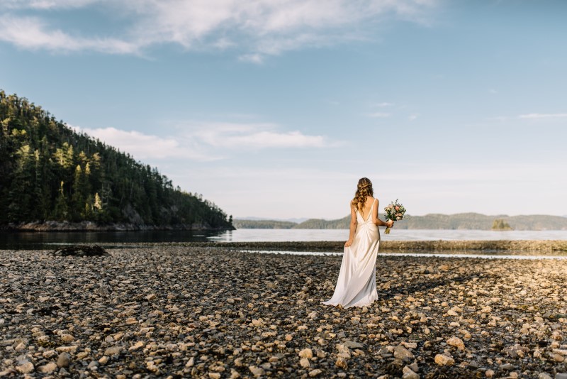 Seaside Romance Bride Walking Along Stony Beach by Masika May Photography