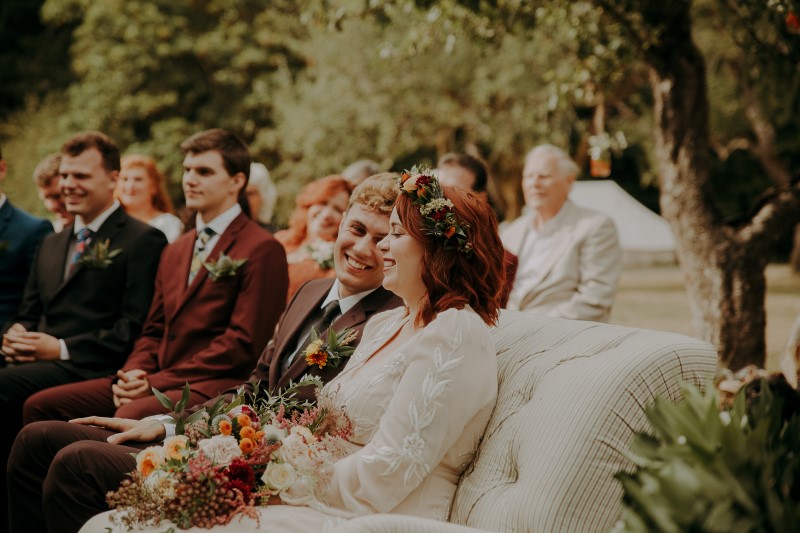 Wedding Couple on settee during ceremony vows at Bilston Creek Farm LumiPhoto