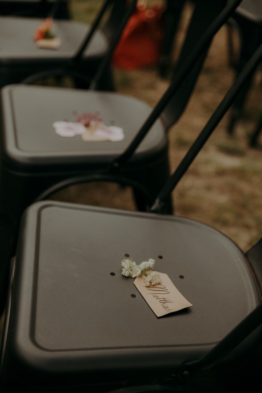 Charming Farm Wedding seats with name cards attached to flowers at Bilston Creek Farm