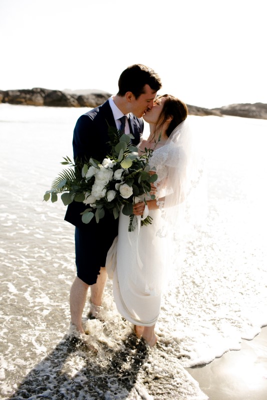 Wedding Couple Kiss on Wickaninnish Inn Beach by Sabrina Patrice Photography