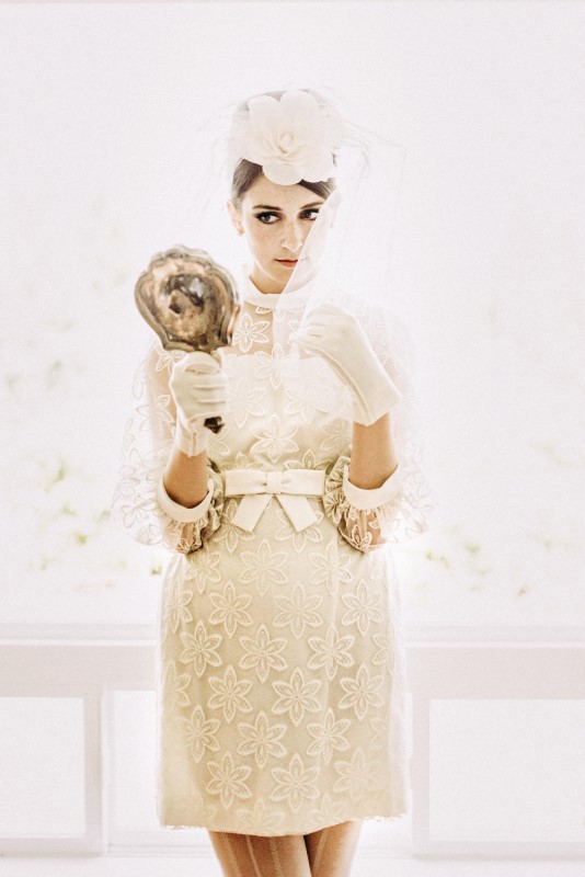 Twiggy Eyes + The Beehive Vintage Inspired Bride holding mirror dressed in lace miniskirt 