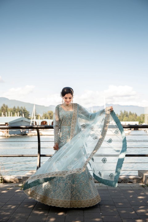 Indian Bride twirls the skirt of her sari in front of Vancouver waterfront 