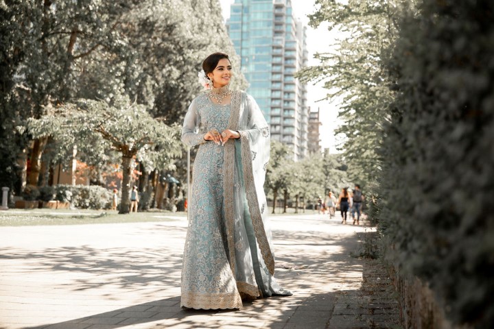 Stylish Wedding at Westin Bayshore bride walks along path in Vancouver