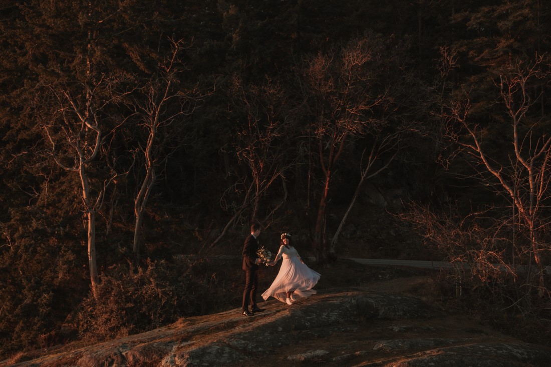 Groom twirls the bride so her gown floats out around her