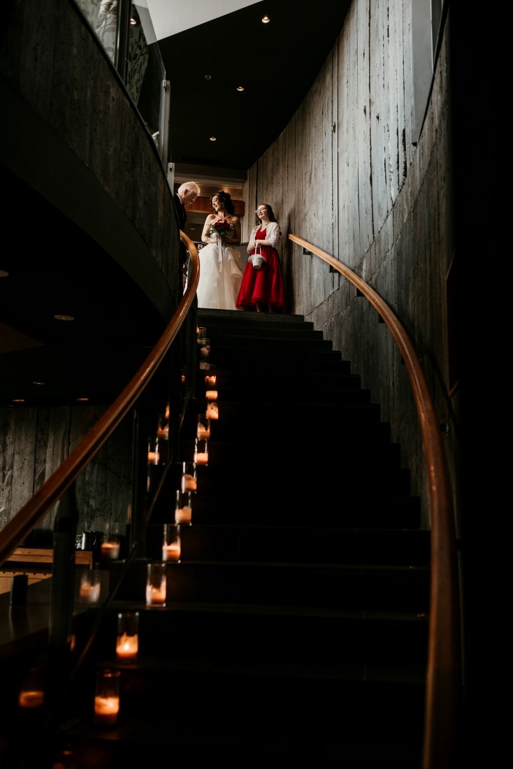 Bride waits to walk down candlelit staircase to Wine Cellar at Black Rock Oceanfront Resort 