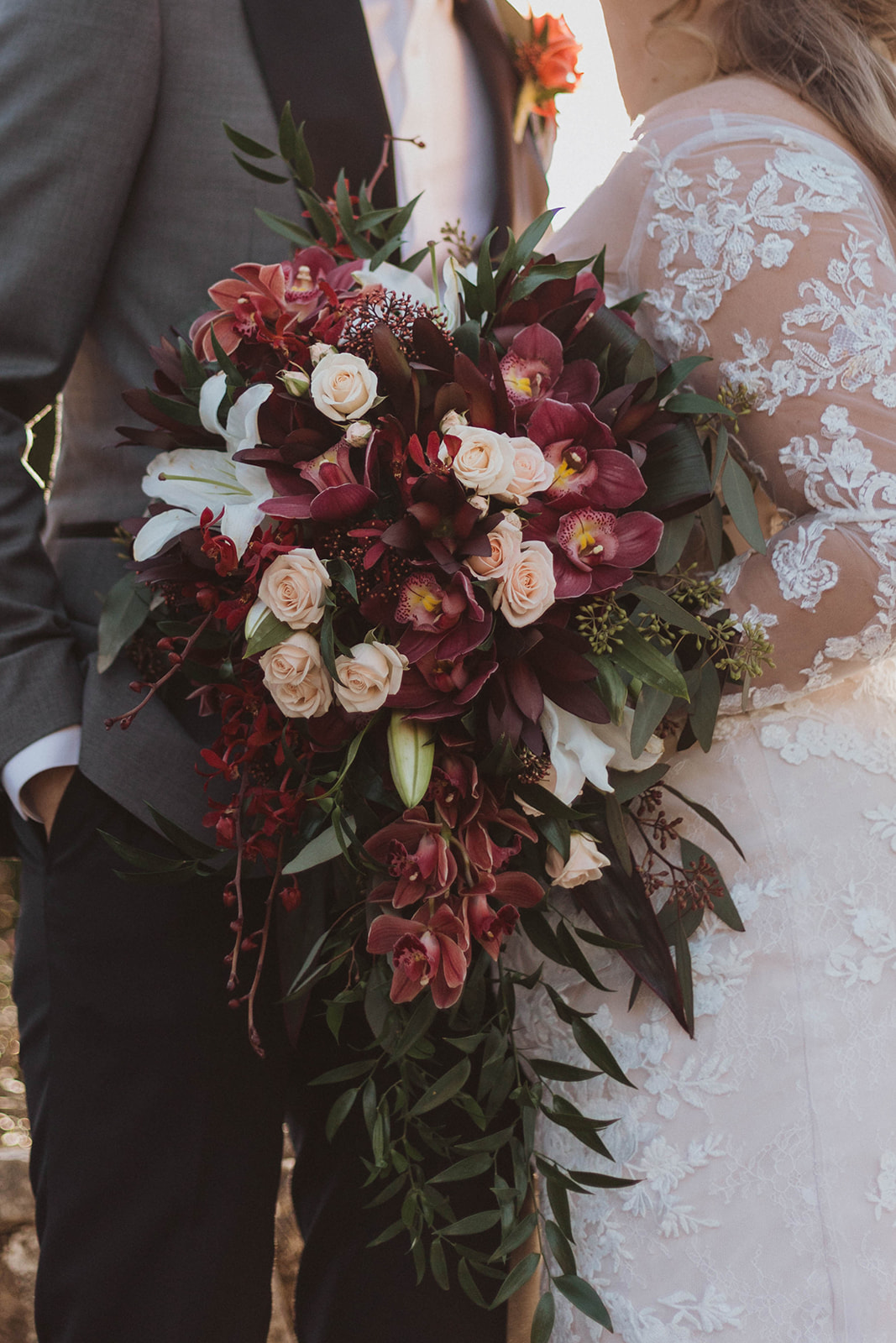 Bridal bouquet of burgundy roses, calla lillies and eucalyptus by Niki Trading in Vancouver