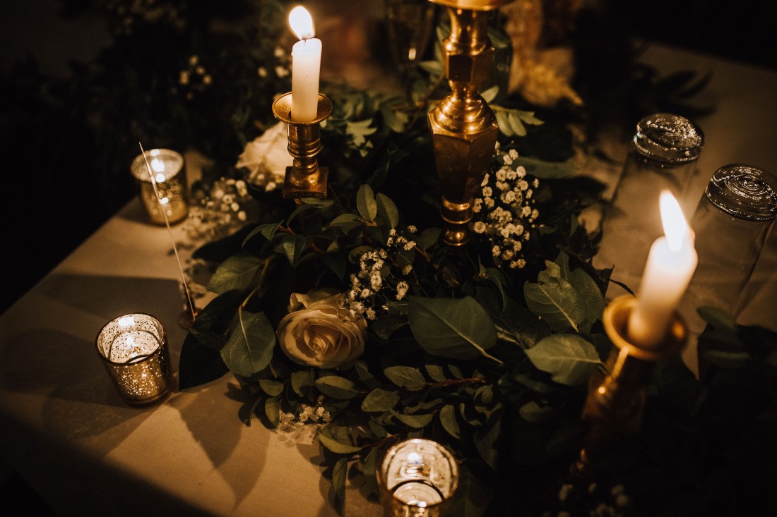 Gold tea candles and floral decor on wedding reception table by Trend Decor Vancouver Island