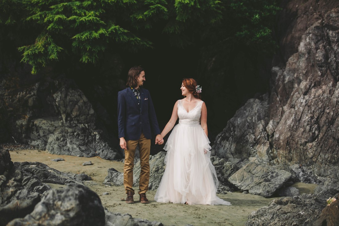 Newlyweds hold hands on Tofino beach by Michelle Milward Photography