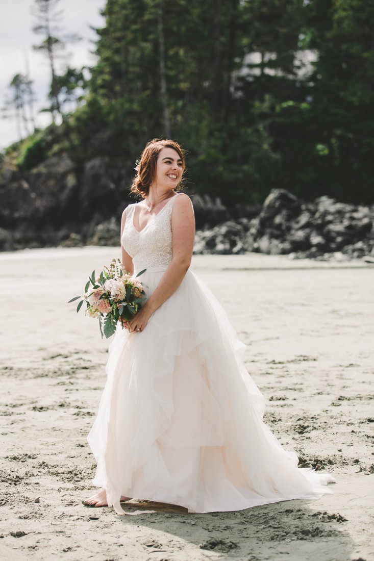 Ocean Wedding bride with bouquet on Tofino beach wearing David's Bridal