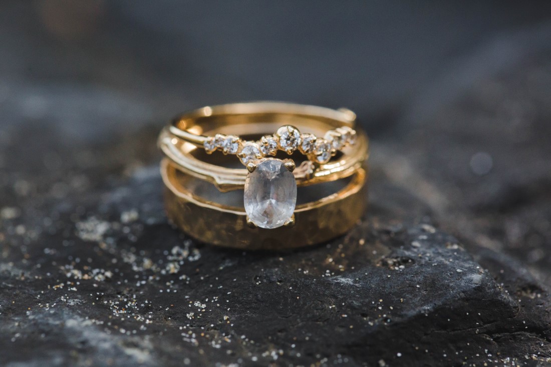 Diamond Rings sitting on rock at Tofino beach by Michelle Milward Photography