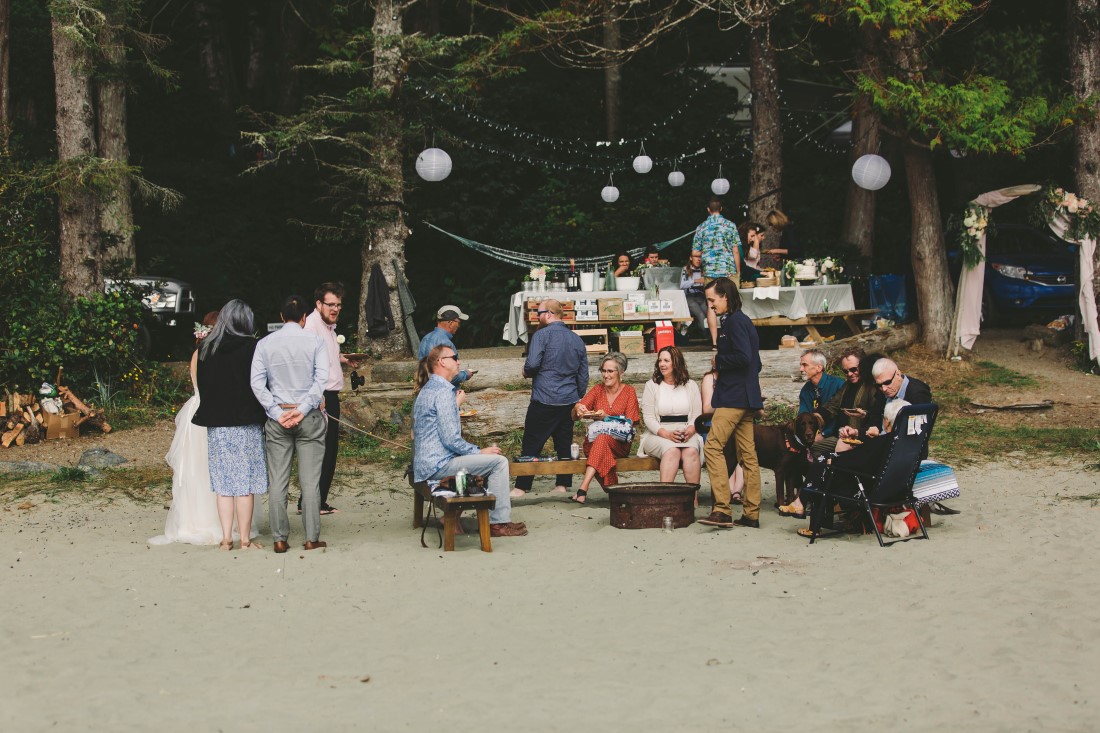 Ocean Wedding Reception Guests enjoy beer and pizza on Tofino beach