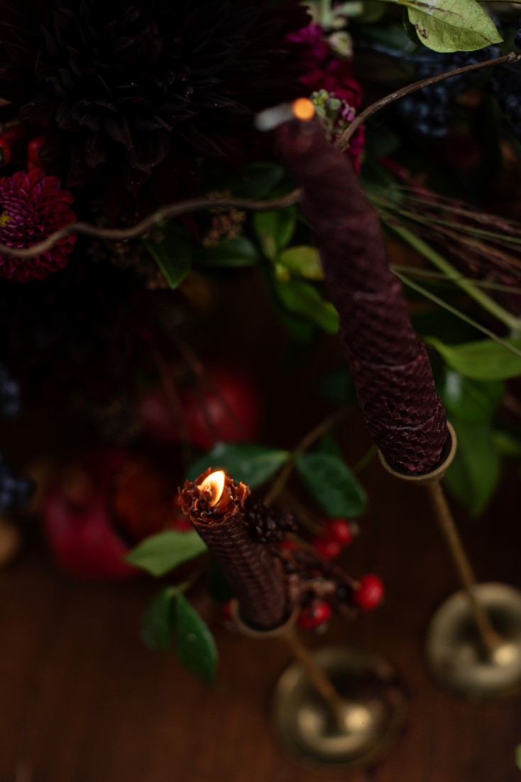 Burgundy beeswax tape candle and gold candlesticks by Thistle and Thorne Weddings