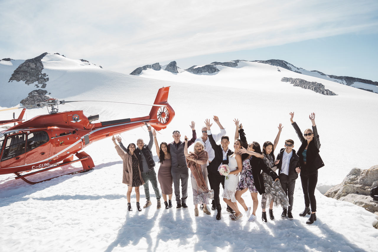 Wedding in the Mountains of Whistler guests stand by helicopter