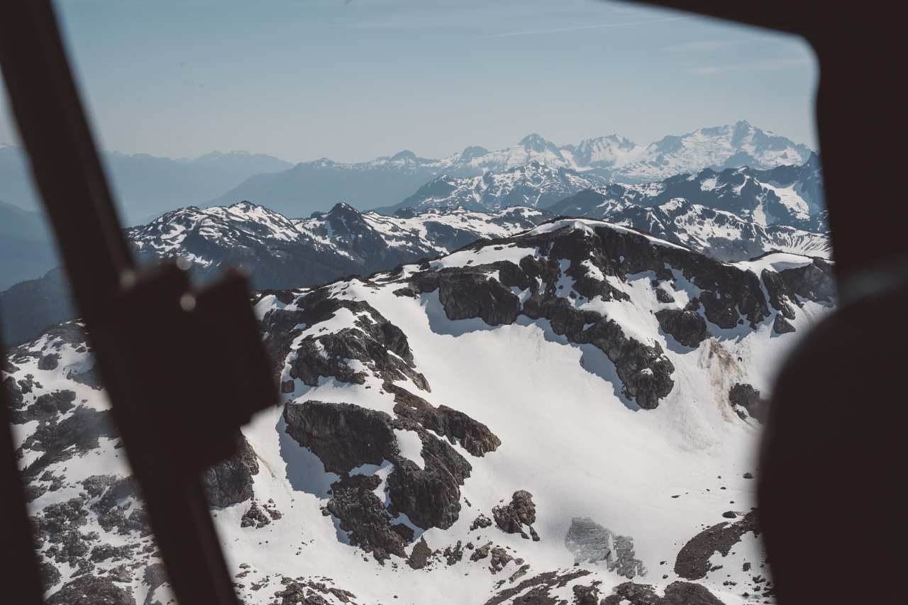 Bride and Groom look out window of Blackcomb helicopter 