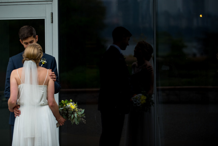 Wedding Couple reflection in the glass at Vancouver Art Museum 