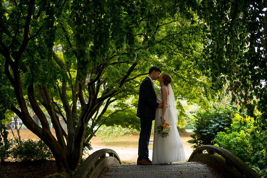 Wedding on the Water couple pose on bride in Vancouver