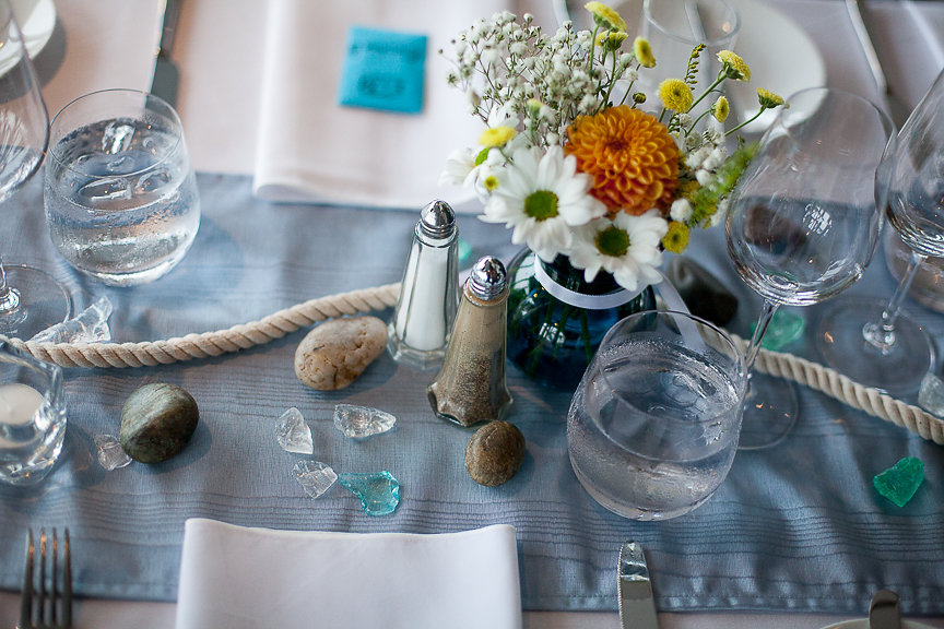 Water themed wedding table with shelles, orange and white gerbera daises