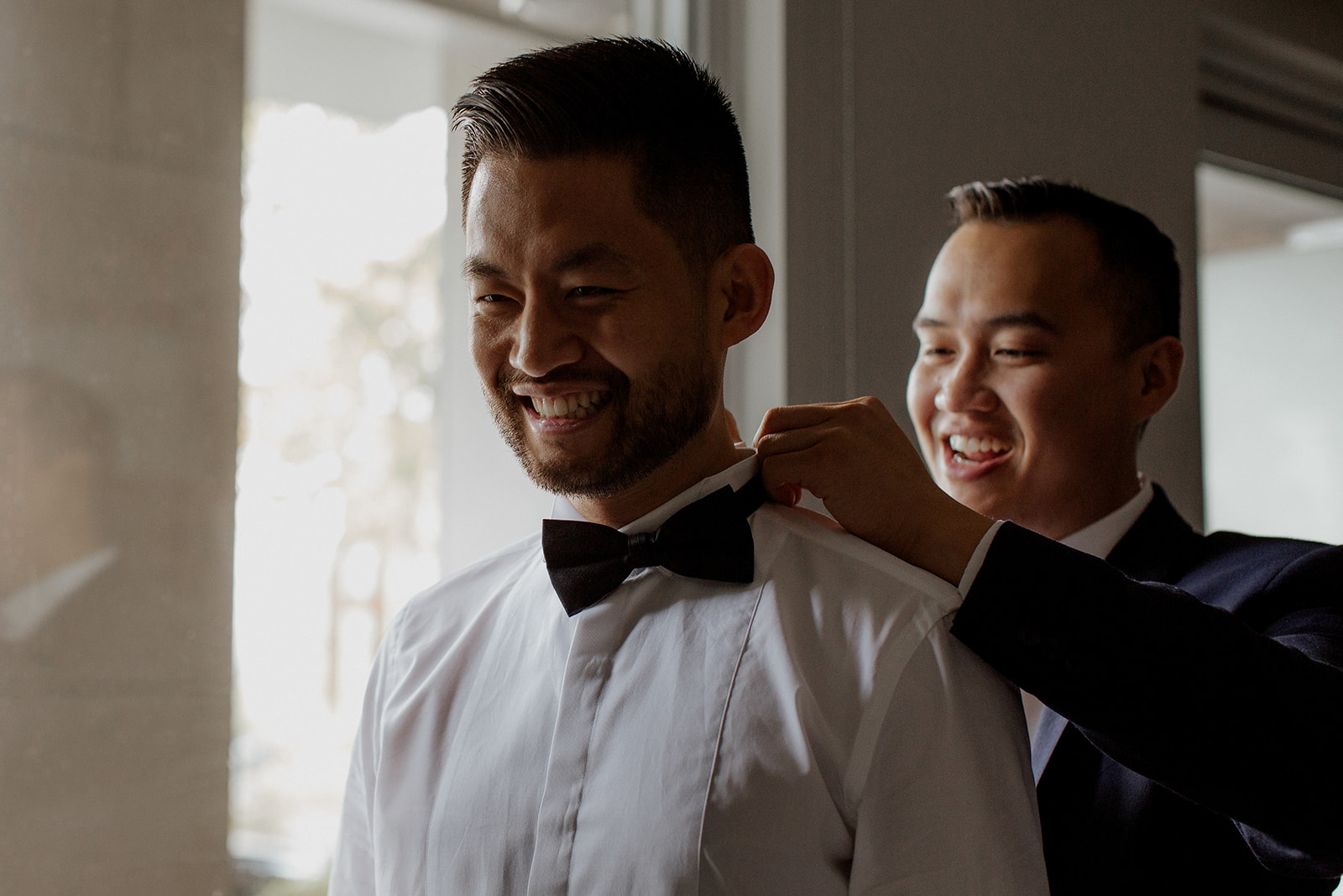 UBC Rose Garden Wedding Groom puts on bow tie 