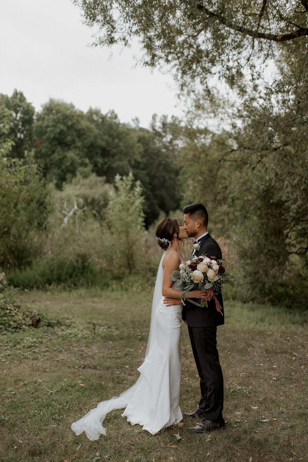 Bride and Groom Kiss at UBC Rose Garden Wedding