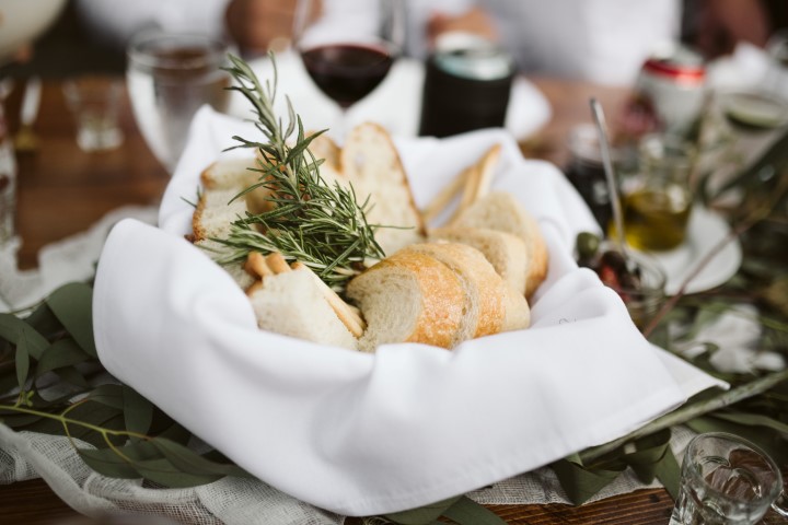 Bread Basket with herbs on wedding reception table by Truffles Catering Vancouver Island