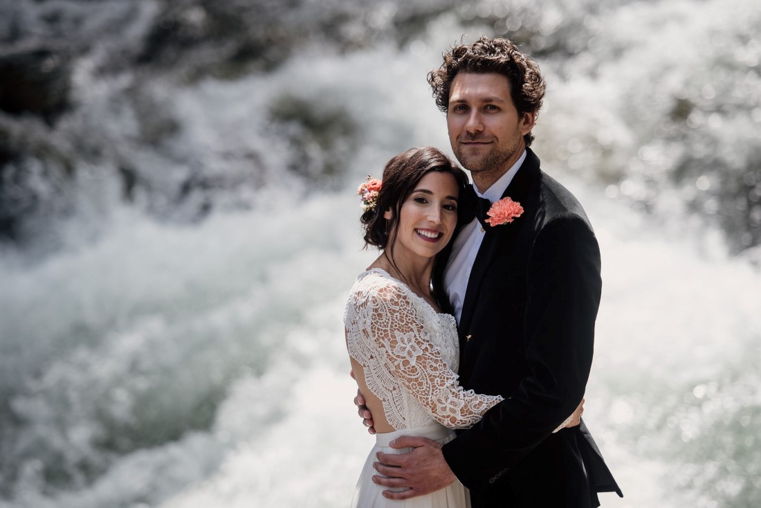 Bride and Groom in front of waterfall near Stone Circle Whistler West Coast Weddings Magazine