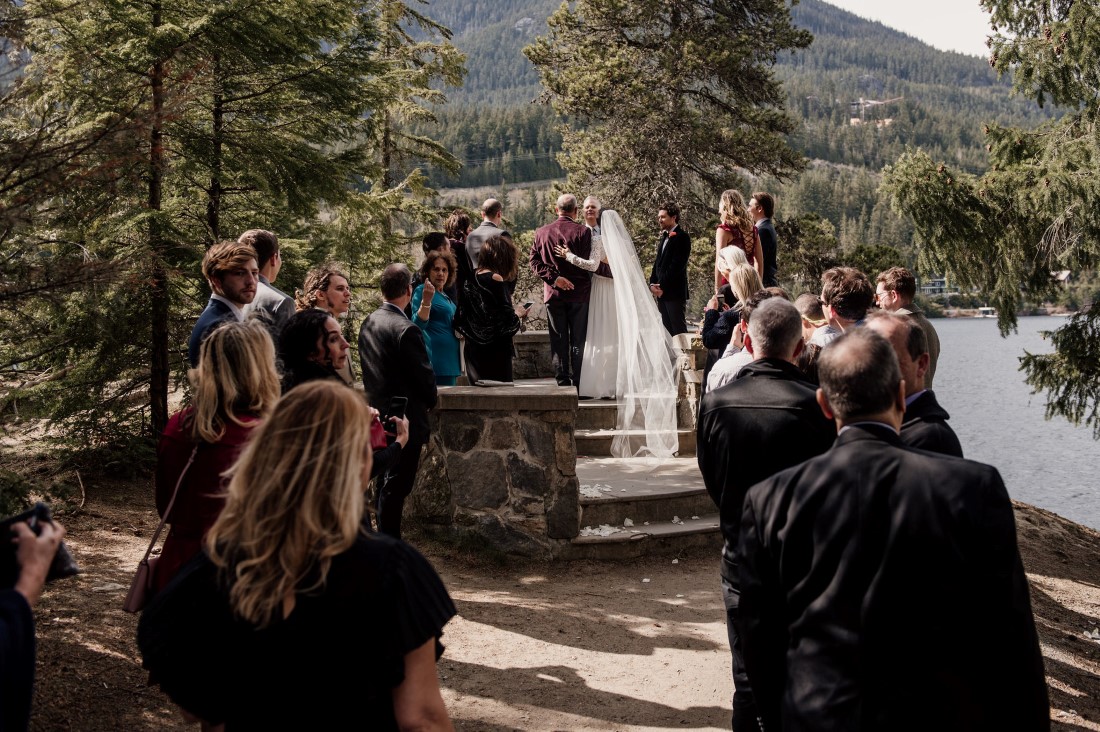 Friends and family surround wedding couple at Stone Circle by Alta Lake BC