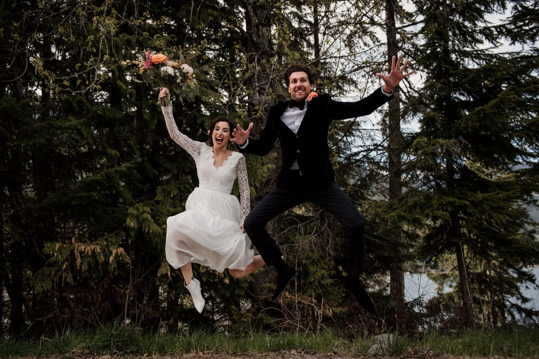 Bride and Groom jump into the air at Stone Circle Whistler by West Coast Weddings Magazine