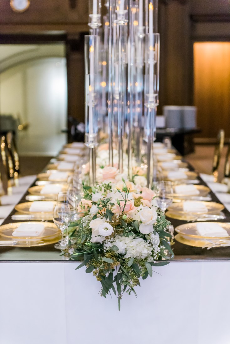 Tall glass vases with white and peach roses on wedding guest table by Elclat Decor Vancouver