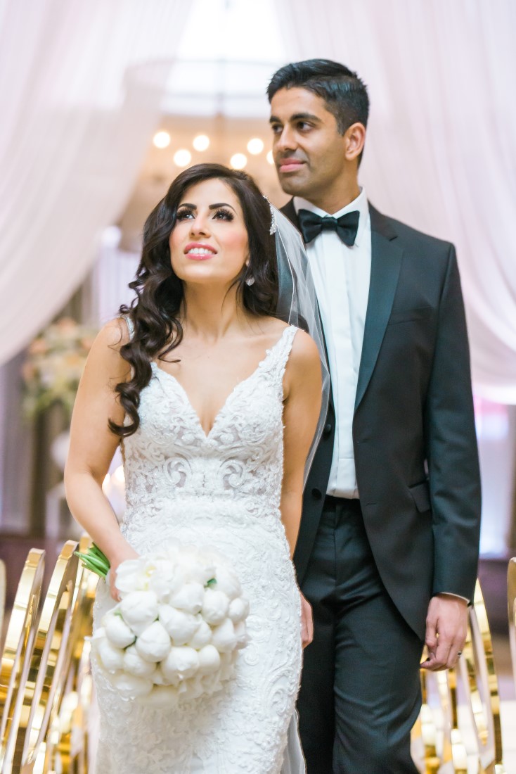 Vancouver Club Wedding Couple walk into their reception by Lestelle Photography