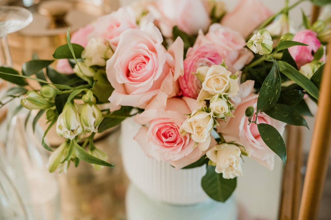 Pink roses in white vase on bridal shower table in Vancouver