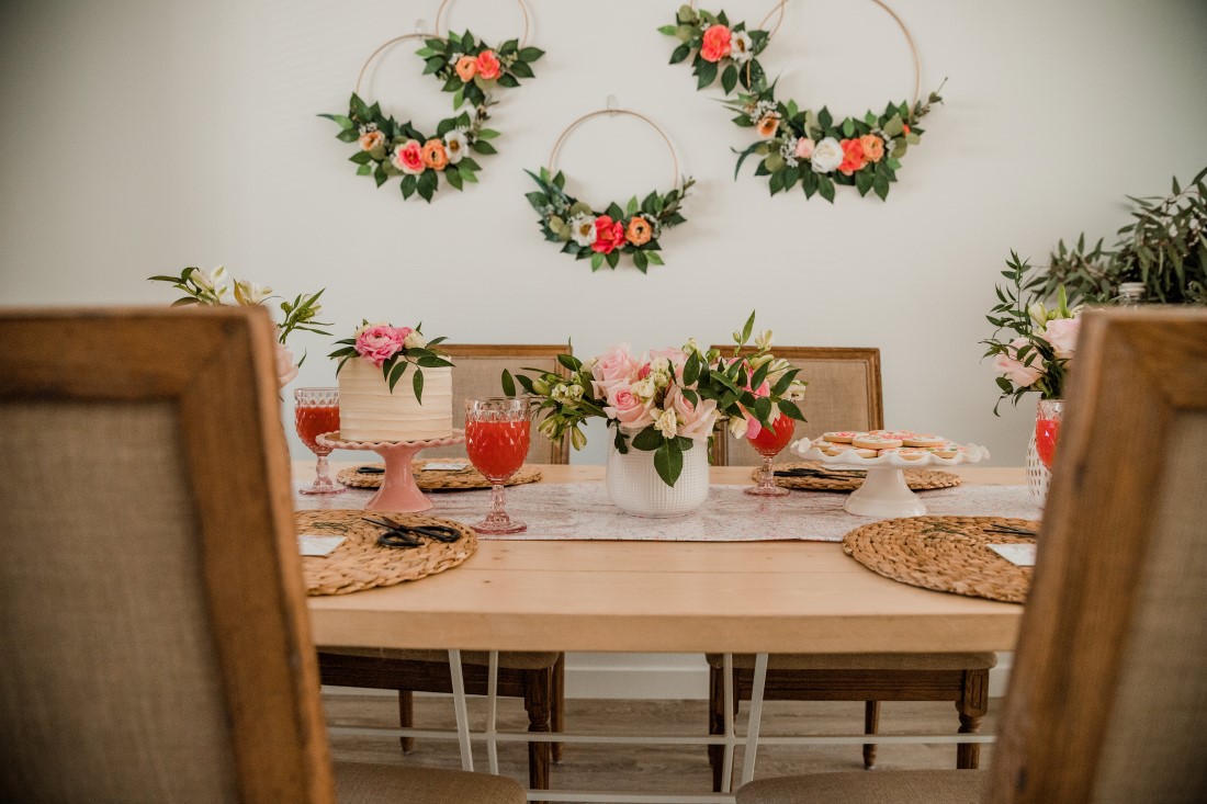 Flower hoops hung on wall as backdrop at bridal shower in Vancouver