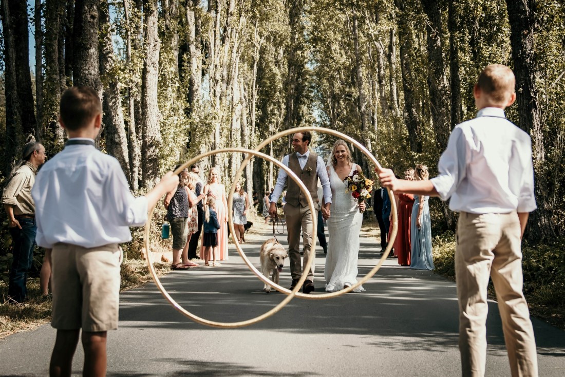 Large hoops in front of bride and groom at outdoor Covid-19 wedding