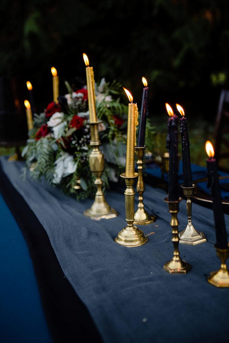 Parade of gold candlesticks on navy linen by Pretty Things Rentals Vancouver