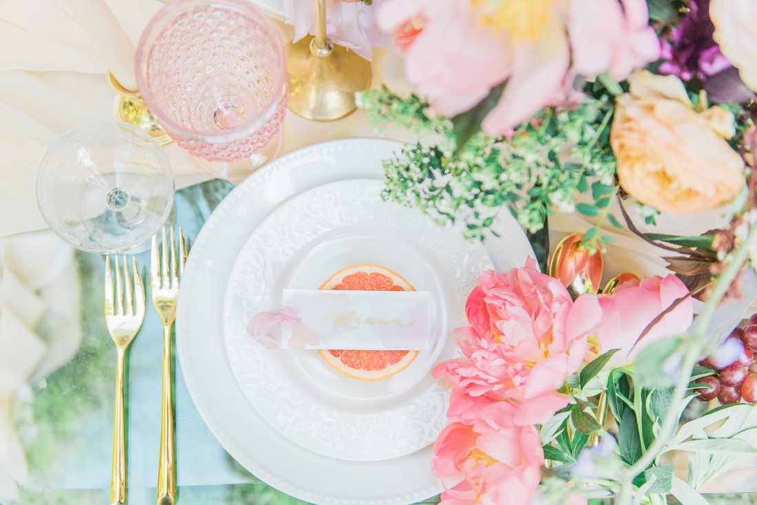 Wedding Reception table with white stacked plates, blush pink peonies, gold cutlery by Ellssi Design and Rentals Vancouver