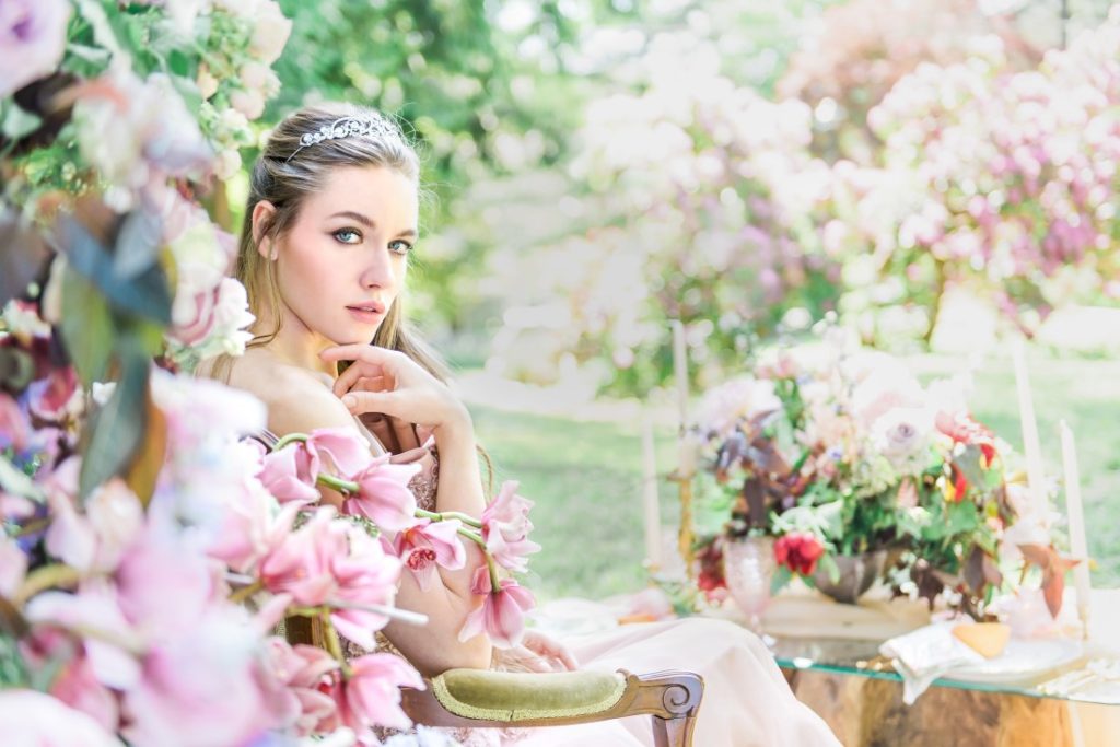 Garden of Eden Bride surrounded by lush flowers in garden