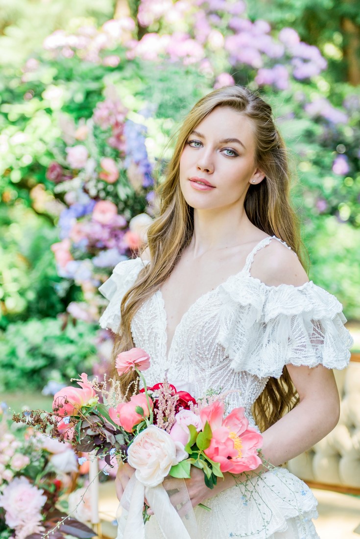 Garden of Eden bride in white gown featuring lace layered sleeves