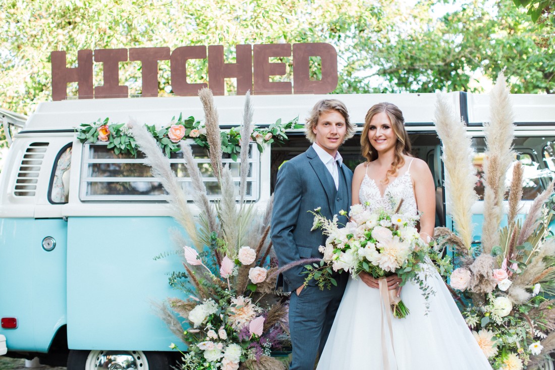 Volkswagon Photobus Elopement newlyweds with Hitched sign in Vancouver