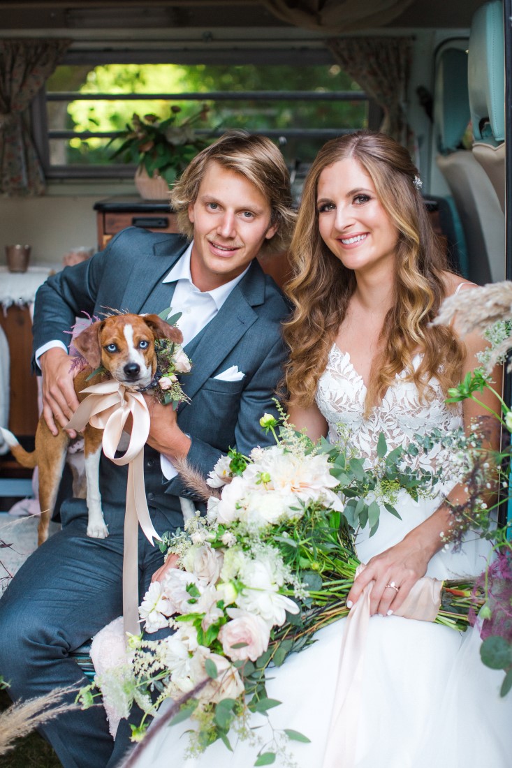 Bride and groom with dog and white bridal bouquet